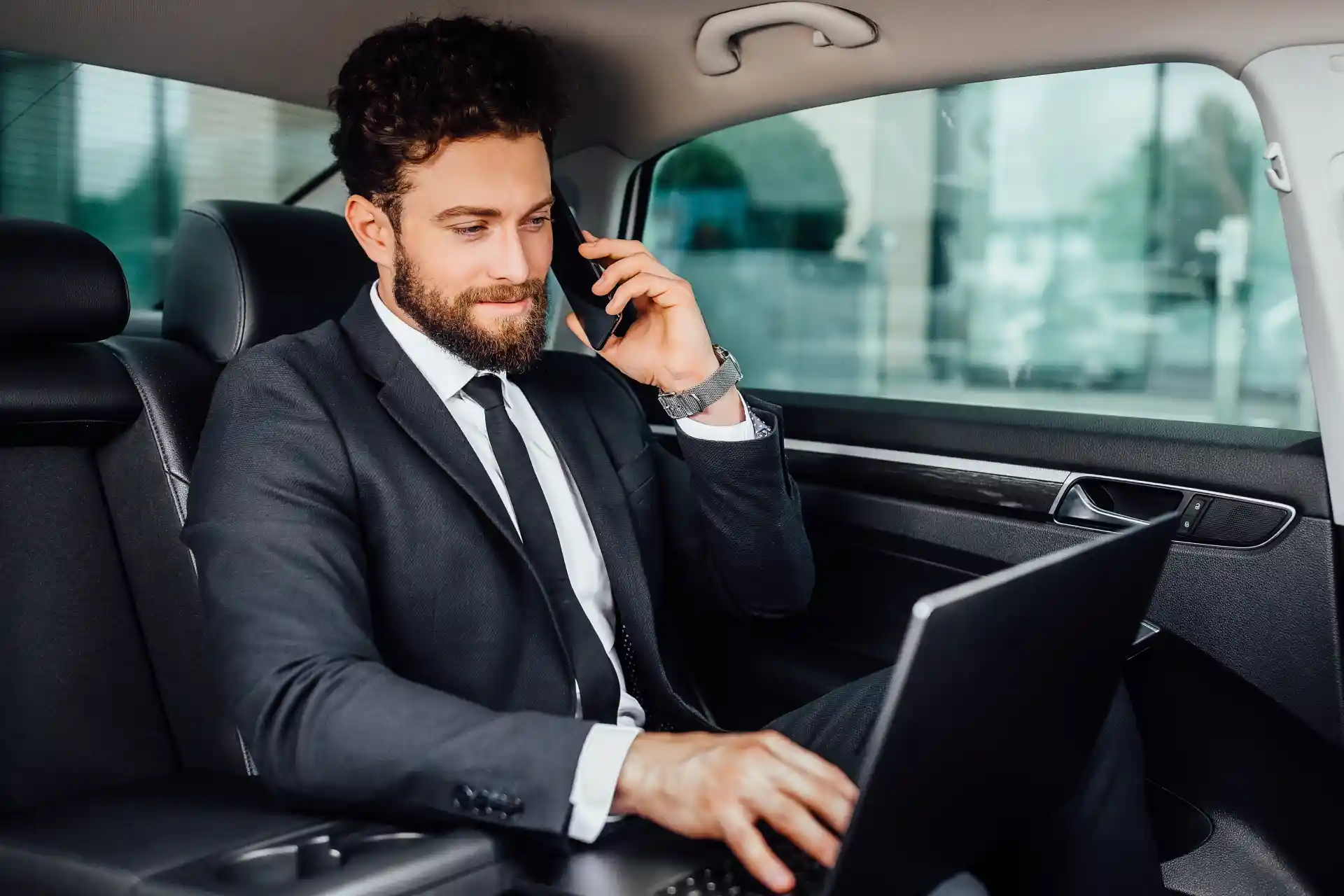 Business traveller working on a laptop during a premium chauffeur service